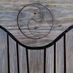 Natural wooden texture featuring a carved yin yang symbol, perfect for design backgrounds.